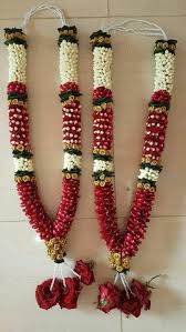 Wedding ceremony ritual traditional jaimala with fresh red roses for bride and groom