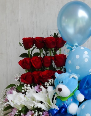 12 Red Roses 4 White lilies with Blue Teddy and 4 Blue Balloons arranged in a basket