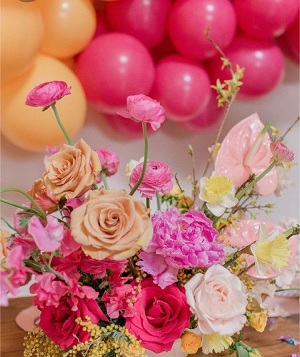 Basket of 20 pink peach white flowers with 20 pink white balloons cluster on top with leaves