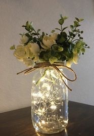 6 White roses in a transparent jar with LED lights