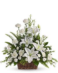 Large arrangement of Roses, liliums and carnations in a basket